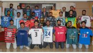 Players displaying their jersey and the trophy of this year’s tournament