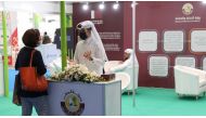 A visitor at the pavilion of Ministry of Commerce and Industry getting information about the initiatives by the Ministry to support Qatari products.
