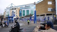 A cameraman films outside Chelsea Football Club's stadium, Stamford Bridge, following Britain's imposing of sanctions on the club's Russian owner, Roman Abramovich, in London, Britain, March 12, 2022. REUTERS/Henry Nicholls