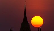 The sun sets behind Wat Saket Temple, or Golden Mount in Bangkok, Thailand, March 15, 2022. Reuters/Athit Perawongmetha