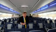 FILE PHOTO: British Airways Chairman Martin Broughton poses for photographs in the world traveller cabin of the British Airways Airbus A380 at Heathrow airport in London July 4, 2013. REUTERS/Paul Hackett