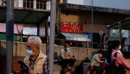 People wear face masks at a park during the coronavirus disease (COVID-19) pandemic in Hong Kong, China, March 16, 2022. REUTERS/Tyrone Siu