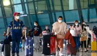 Visitors walk after they arrived at the Soekarno-Hatta Airport following Indonesia's government decision to ban foreign tourists from entry to prevent the spread of coronavirus disease (COVID-19), in Tangerang, on the outskirts of Jakarta, Indonesia, January 1, 2021. REUTERS/Ajeng Dinar Ulfiana/File Photo