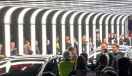 People take pictures of Elon Musk during a delivery ceremony inside the new Tesla Gigafactory for electric cars in Gruenheide, Germany, March 22, 2022. REUTERS/Nadine Schimroszik
