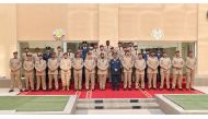 Commander of the Amiri Guard Staff Lieutenant-General Hazza bin Khalil Al Shahwani and other officials pose with the course graduates.  
