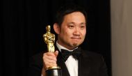 Director Ryusuke Hamaguchi poses with the Oscar for Best International Feature Film for 