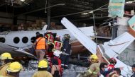 Rescue personnel inspect the wreckage of a small plane that crashed into a supermarket, in Temixco, in Morelos state, Mexico March 28, 2022. REUTERS/Margarito Perez