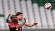 Qatar’s Abdelkarim Hassan and Slovenia’s Petar Stojanovic vie for the ball during their friendly at the Education City Stadium, yesterday.