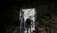 A Ukrainian service member walks on the front line near Kyiv as Russia's invasion of Ukraine continues, Ukraine March 29, 2022. REUTERS/Gleb Garanich