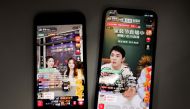 Livestreaming sessions by Chinese livestreamers Li Jiaqi and Viya, whose real name is Huang Wei, (L) are seen on Alibaba's e-commerce app Taobao displayed on mobile phones in this illustration picture taken December 14, 2021. REUTERS/Florence Lo/Illustration/File Photo