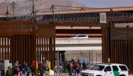 Migrants are detained by U.S. Border Patrol agents after crossing the Rio Bravo river to turn themselves in to request for asylum in El Paso, Texas, U.S., as seen from Ciudad Juarez, Mexico, February 24, 2022. REUTERS/Jose Luis Gonzalez


