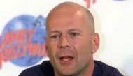 Hollywood star Bruce Willis talks to reporters during a news conference in a Planet Hollywood restaurant at a new cinema and shopping complex in an Athens suburb August 23, 2000. Willis is on a 24-hour visit to the Greek capital to promote the restaurant. YK/JRE/File Photo