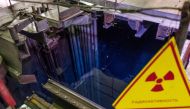 FILE PHOTO: A view of fuel assemblies in water with a sign reading 