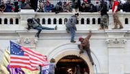 A mob of supporters of U.S. President Donald Trump fight with members of law enforcement at a door they broke open as they storm the U.S. Capitol Building in Washington, U.S., January 6, 2021. REUTERS/Leah Millis/File Photo


