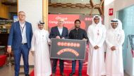 One of the winners of  'Win with Hala campaign', with Ooredoo officials.
