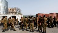 Police officers guard a street where shipping containers have been used to block the road leading towards the Red Zone and parliament building, in Islamabad, Pakistan April 3, 2022. Reuters/Akhtar Soomro