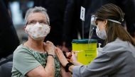 A woman receives a COVID-19 vaccine at a clinic, as efforts continue to help slow the spread of the coronavirus disease, in Ottawa, Ontario, Canada March 30, 2021. REUTERS/Blair Gable/File Photo