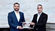 Mycrane founder and CEO Andrei Geikalo (left) signs a franchise agreement for Qatar with Kamal Kassab , managing director and founder of Ant Dynamics.
