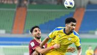 Al Gharafa's Homam Ahmed vies for the ball with Foolad's S. Ansari during yesterday's match.
