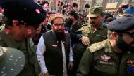 File photo: Hafiz Saeed is showered with flower petals as he walks to court before a Pakistani court ordered his release from house arrest in Lahore, Pakistan November 22, 2017. Reuters/Mohsin Raza/File Photo