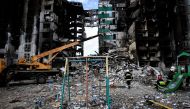 A rescuer walks during a search operation for bodies under the rubble of a building destroyed by Russian shelling, amid Russia's Invasion of Ukraine, in Borodyanka, Kyiv region, Ukraine April 11, 2022. REUTERS/Zohra Bensemra