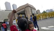 A woman carries her baby and shouts slogans on the fourth consecutive day of protests against Sri Lankan President Gotabaya Rajapaksa in front of the Presidential Secretariat, amid the country's economic crisis, in Colombo, Sri Lanka, April 12, 2022. REUTERS/Dinuka Liyanawatte