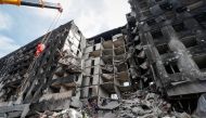 Emergency workers remove debris of a building destroyed in the course of the Ukraine-Russia conflict, in the southern port city of Mariupol, Ukraine April 10, 2022. REUTERS/Alexander Ermochenko
