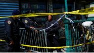 Law enforcement officers stand guard at the scene of a shooting at a subway station in the Brooklyn borough of New York City, New York, U.S., April 12, 2022. Reuters/Eduardo Munoz
