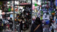 A woman looks into the shop window of a home goods store as inflation in Argentina hits its highest level in years, causing food prices to spiral, in Buenos Aires, Argentina April 12, 2022. Picture taken April 12, 2022. REUTERS/Mariana Nedelcu