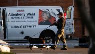A law enforcement officer conducts an investigation of a van that police say is connected with the shooting at a subway station in the Brooklyn borough of New York City, New York, U.S., April 12, 2022. REUTERS/Eduardo Munoz