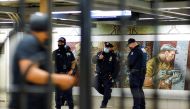 New York Police officers stand guard inside the 36th St. subway station, a day after a shooting incident took place in the Brooklyn borough of New York City, U.S., April 13, 2022. REUTERS/Eduardo Munoz


