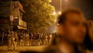 Police personnel stand guard after clashes broke out during a Hindu religious procession in Jahangirpuri area of New Delhi, India, April 16, 2022. Reuters/Stringer 
