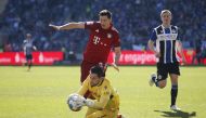 Bayern Munich's Robert Lewandowski in action with Arminia Bielefeld's Stefan Ortega REUTERS/Leon Kuegeler DFL REGULATIONS PROHIBIT ANY USE OF PHOTOGRAPHS AS IMAGE SEQUENCES AND/OR QUASI-VIDEO.
