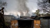 A firefighter tries to extinguish a fire burning at a garage, following Russian shelling, amid Russia's attack on Ukraine, in Kharkiv, Ukraine, April 18, 2022. REUTERS/Alkis Konstantinidis/File Photo