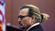 Actor Johnny Depp watches the jury leave as a lunch break starts during his defamation case against ex-wife Amber Heard at the Fairfax County Circuit Courthouse in Fairfax, Virginia, U.S., April 18, 2022. Steve Helber/Pool via REUTERS
