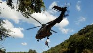 A member of a search and rescue team airlifts a body from the Mzinyathi River after heavy rains caused flooding near Durban, South Africa, April 19, 2022. REUTERS/Rogan Ward