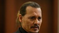 Actor Johnny Depp looks on at the Fairfax County Circuit Courthouse as his defamation case against ex-wife Amber Heard continues, in Fairfax, Virginia, U.S., April 19, 2022. Jim Watson/Pool via REUTERS