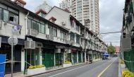 Green fences seal entrances to shops and housing units along a street, amid the coronavirus disease (COVID-19) outbreak in Shanghai, China April 24, 2022. Reuters/Jacqueline Wong