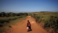 Kazy Zanapizo walks to her field in the village of Ambory, Erada commune, Androy region, Madagascar, February 16, 2022. Picture taken February 16, 2022. REUTERS/Alkis Konstantinidis


