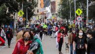 People wearing face masks walk down a street before the start of a mandatory total isolation decreed by the mayor's office, amidst an outbreak of the coronavirus disease (COVID-19), in Bogota, Colombia January 7, 2021. REUTERS/Luisa Gonzalez/File Photo/File Photo