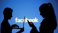 FILE PHOTO: People are silhouetted as they pose with laptops in front of a screen projected with a Facebook logo, in this picture illustration taken in Zenica October 29, 2014. REUTERS/Dado Ruvic/File Photo
