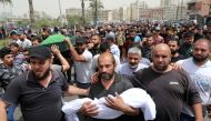 :A father holds the body of his child who died after a small dinghy carrying around 60 people sunk off the coast near the port city of Tripoli on Saturday night, during a funeral in Tripoli, Lebanon April 25, 2022. REUTERS/Mohamed Azakir
