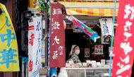 A woman wearing protective mask waits for customers at a market district in Tokyo, Japan May 13, 2020.REUTERS/Kim Kyung-Hoon/File Photo