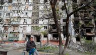 Local resident Tatiana Bushlanova, 64, sits on a bench near an apartment building heavily damaged during Ukraine-Russia conflict in the southern port city of Mariupol, Ukraine May 2, 2022. REUTERS/Alexander Ermochenko