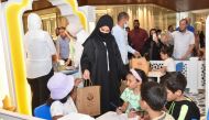 A representative of Al Rayyan Municipality distributing Eid gifts among children. 