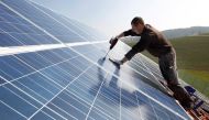 A worker mounts 320 square metres of solar panels on the roof of a farmstead barn in Binsham near Landshut March 21, 2012./File Photo