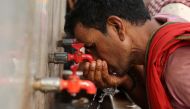 FILE PHOTO: A labourer drinks water from a public drinking water tap on a hot summer day in the old quarters of Delhi, India, May 4, 2022. REUTERS/Anushree Fadnavis/File Photo
