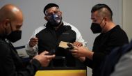 Travelers wait in line to get tests for the coronavirus disease (COVID-19) at a pop-up clinic at Tom Bradley International Terminal at Los Angeles International Airport, California, U.S., December 22, 2021. REUTERS/Bing Guan

