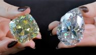 Returning for the third time since its mining in 1901, the 'Red Cross', a fancy intense yellow, cushion-shaped 205.07 carat diamond and a 228.31 carat white diamond called 'The Rock' that could fetch 30 million US dollars and is the largest ever seen throughout auction market history, are pictured during a preview at Christie's before their auction sale in Geneva, Switzerland, May 6, 2022. REUTERS/Denis Balibouse