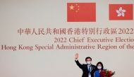John Lee waves with his wife Janet Lam Lai-sim on stage after being elected as Hong Kong's Chief Executive, in Hong Kong, China, May 8, 2022. Reuters/Tyrone Siu
